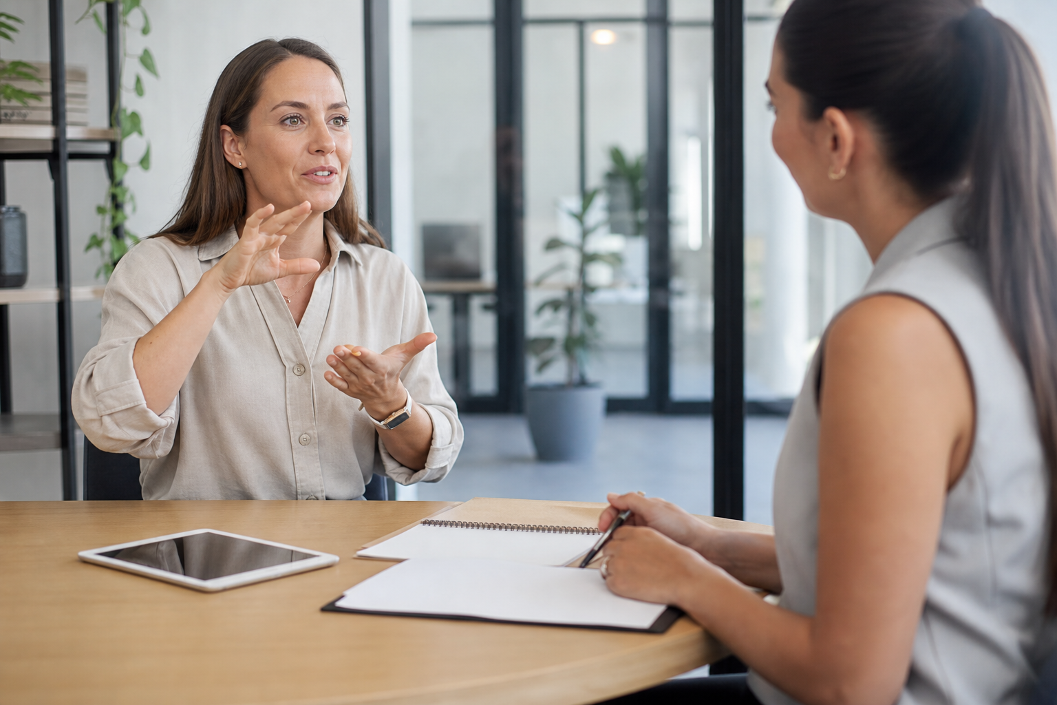 Adult female NDIS participant using Auslan during a career progression meeting with a career counsellor