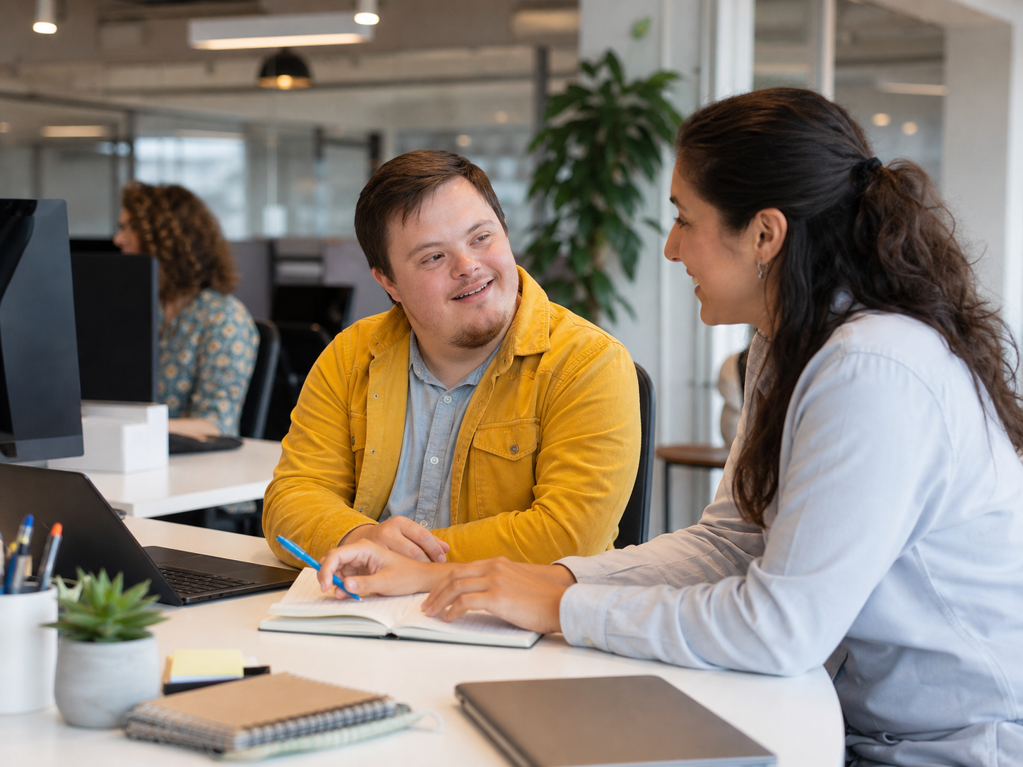 An adult NDIS participant planning career goals with a career counsellor