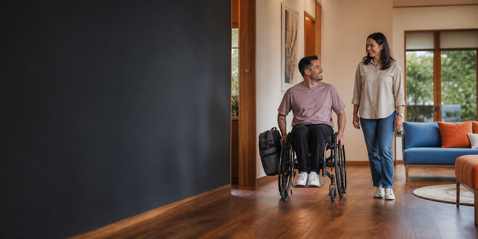 An adult NDIS participant arriving at a modern accessible short-term accommodation home with a support worker
